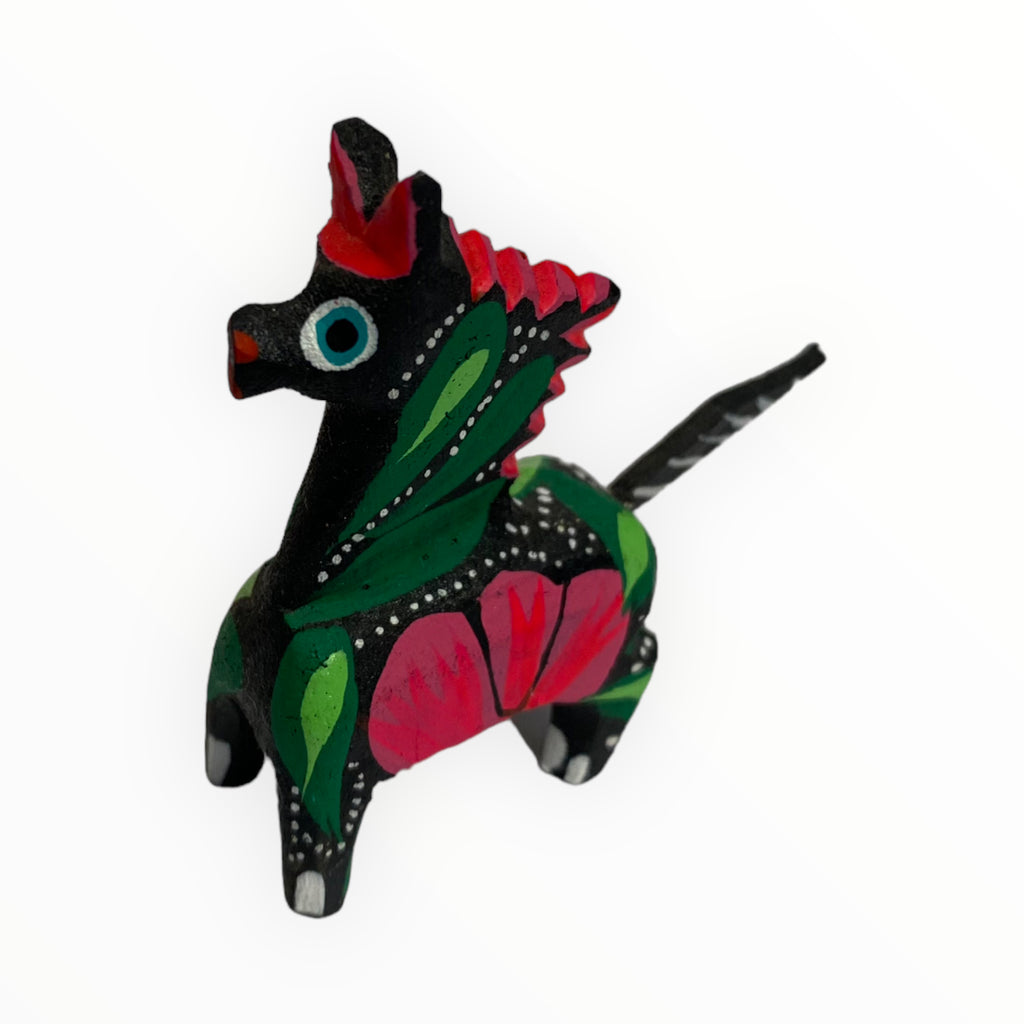 Indulge in the elegance of our handcrafted black alebrije pony sculpture. Meticulously carved and featuring a sleek black finish, this sculpture blends traditional Oaxacan craftsmanship with a touch of sophistication, making it a unique and striking piece of art.