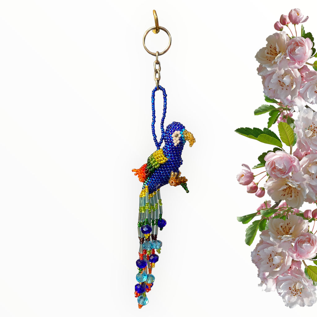 Embrace elegance with our Navy Blue Beaded Parrot Keychain. This artisanal creation showcases a regal navy blue body complemented by a golden beak, vibrant multicolor wings reminiscent of tropical splendor, and a gentle light blue tail adorned with a whimsical array of colorful beads. It's a versatile accessory that effortlessly adds sophistication and charm to your daily ensemble.