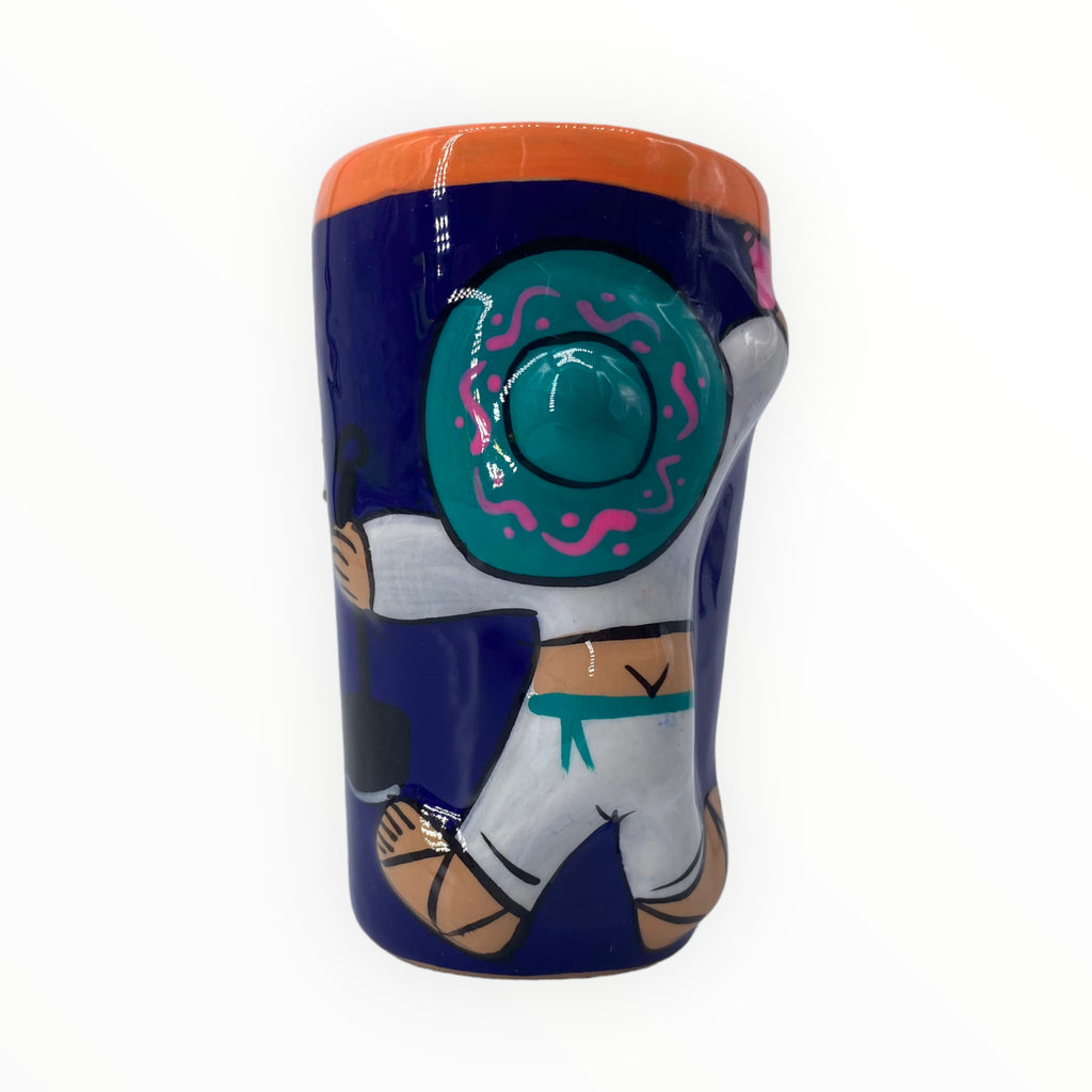 Navy Blue Mariachi and Cactus Hand-Painted Shot Glass. Raise a toast to Mexican charm with our Navy Blue Mariachi and Cactus Hand-Painted Shot Glass. The deep navy blue sets the scene for a mariachi musician on the front and a delightful cactus on the back. Crafted with care and hand-painted, it's a distinctive addition to your shot glass collection.