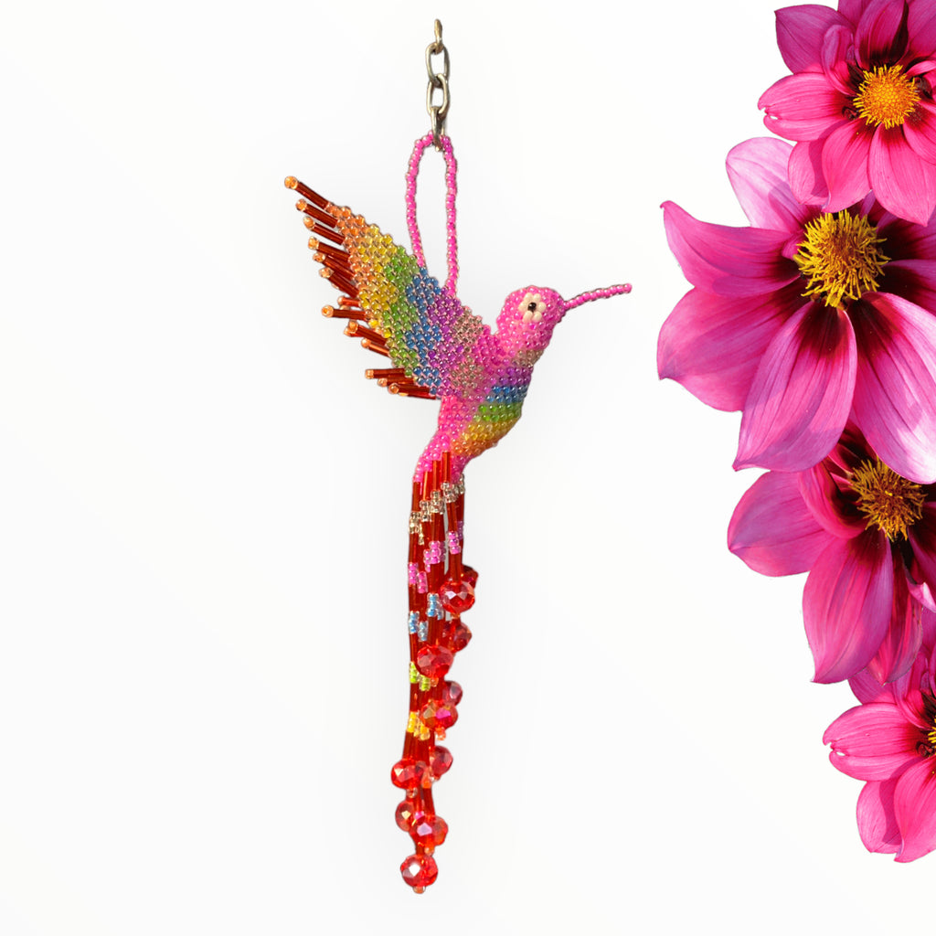 Playful pink and red hummingbird keychain adorned with neon accents, a vibrant statement piece