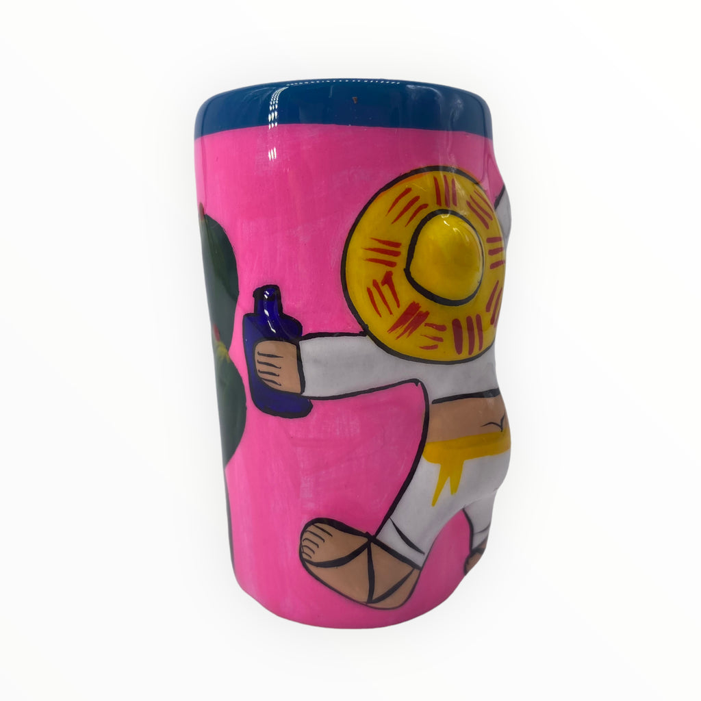 Neon Pink Mariachi and Cactus Hand-Painted Shot Glass.Add a pop of vibrant color to your collection with our Neon Pink Mariachi and Cactus Hand-Painted Shot Glass. The front features a funny  mariachi character, while the back showcases a charming cactus design. 